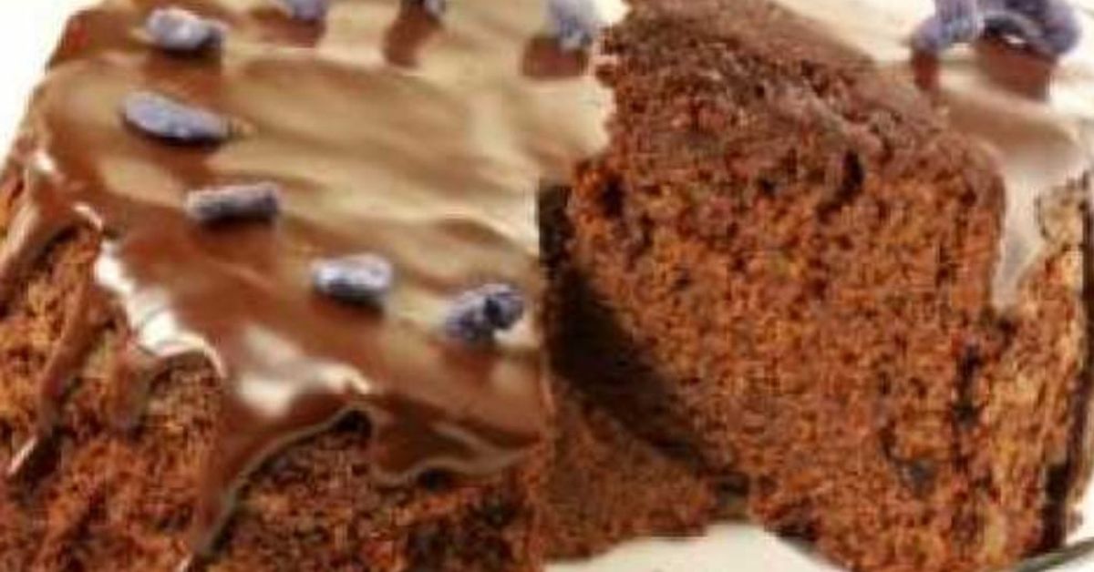 Опитайте тази торта с шоколад – готова за минути, вкусна като от сладкарница Шоколадова торта с глазура, украсена с малки елементи и отрязано парче.