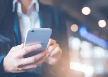 Business women hand are using cell phones in office.