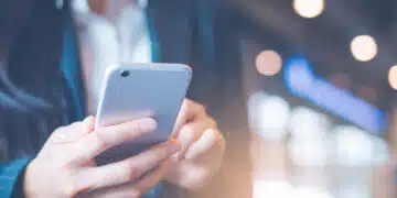 Business women hand are using cell phones in office.