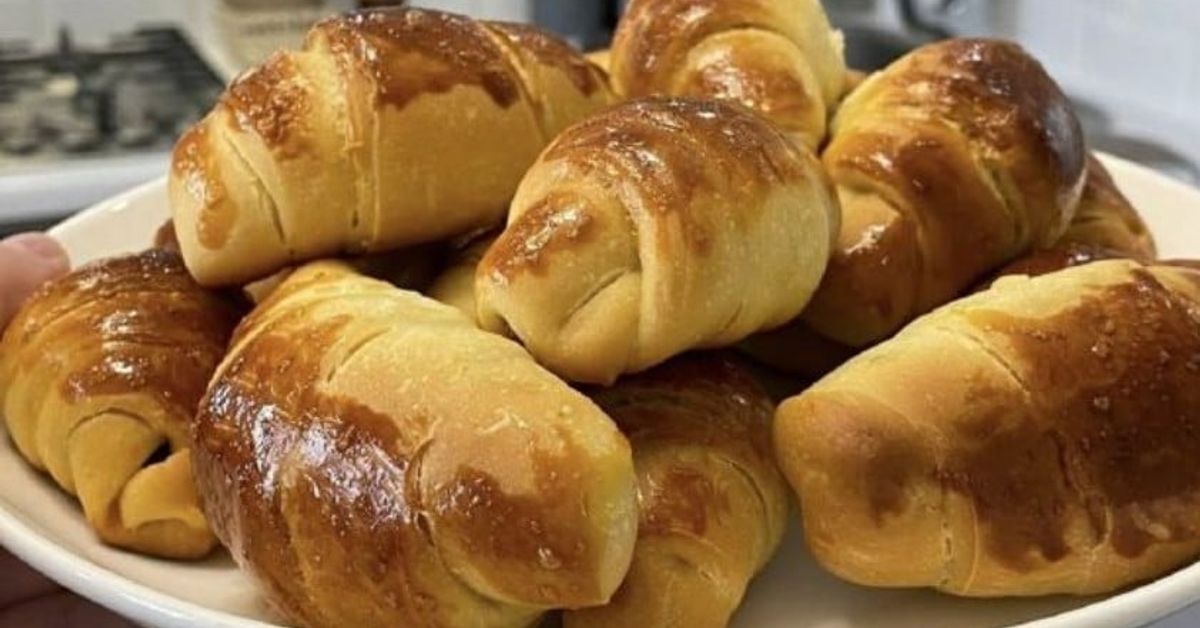 Много вкусни и крехки кроасани с кефир: всеки може да ги приготви Апетитни, прясно изпечени кифлички със златиста коричка на бяла чиния.